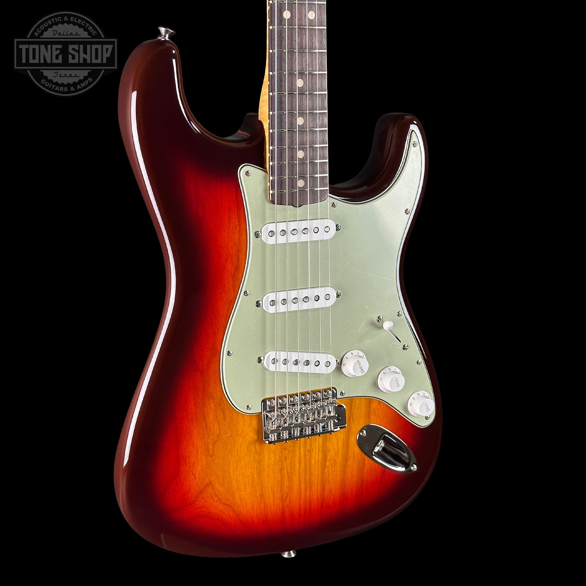 Electric guitar with a sunburst finish on a black background, featuring the Tone Shop logo.