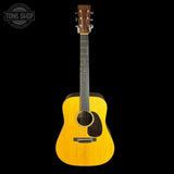 Aged Toner acoustic guitar on a black background with 'Tone Shop' logo.