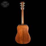Back view of a mahogany acoustic guitar on a black background with 'Tone Shop' logo.