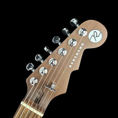 Front of headstock of Used Reverend Charger RA Trans Black.