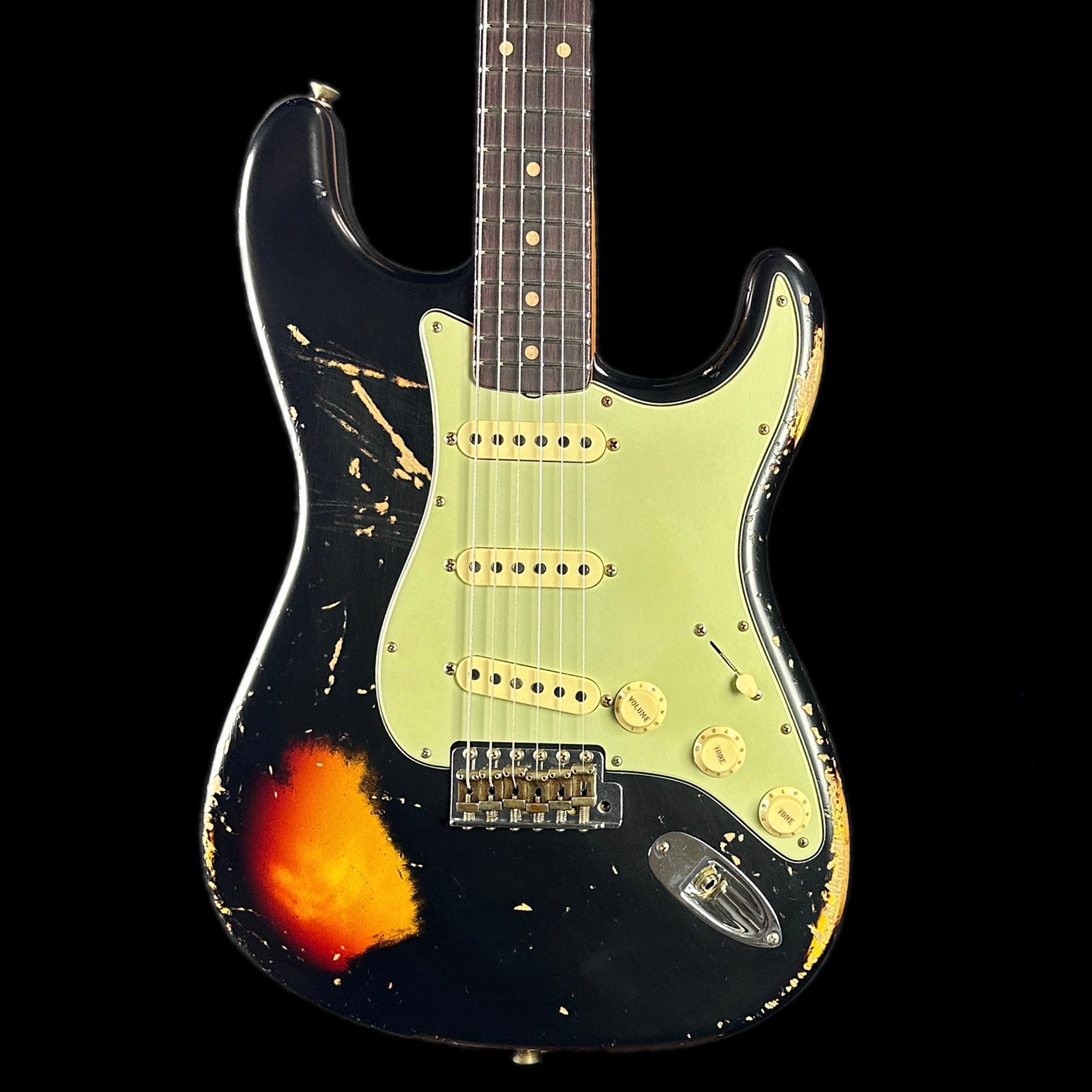 Front of body of Fender Custom Shop Limited Edition '62 Strat Heavy Relic Aged Black Over 3 Color Sunburst.