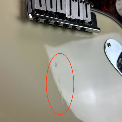 Scratch near bridge of Used 1996 Fender Lone Star Strat White.