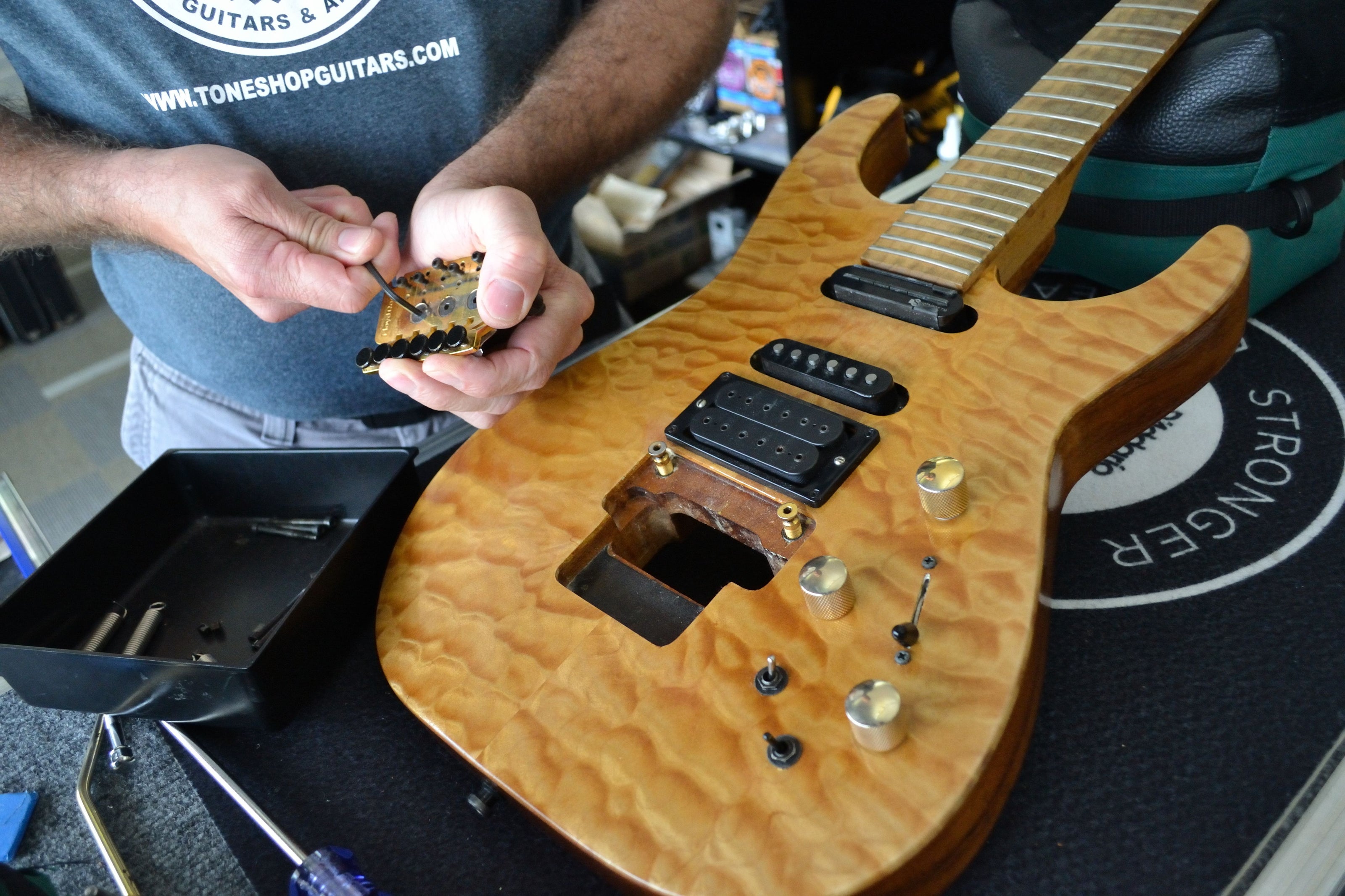 Tone Shop Guitars employee repairing at electric guitar in Dallas Fort Worth TX
