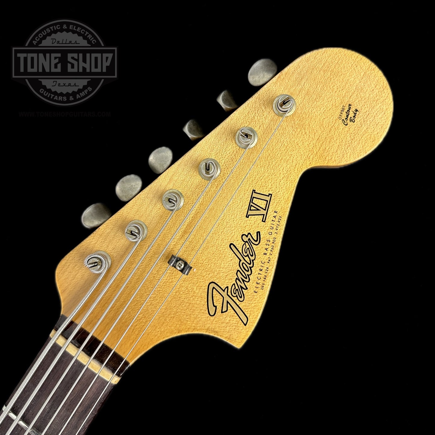 Front of headstock of Fender Custom Shop Limited Edition Bass VI Journeyman Relic Aged Dakota Red.