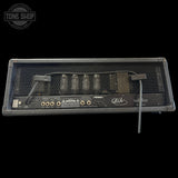 Back view of a guitar amplifier with visible branding on a black background