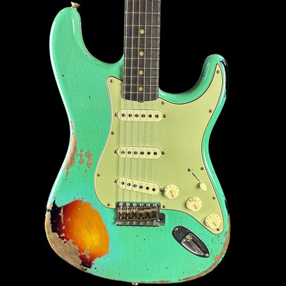 Front of body of Fender Custom Shop Limited Edition '62 Strat Heavy Relic Faded Aged Sea Foam Green Over 3 Color Sunburst.