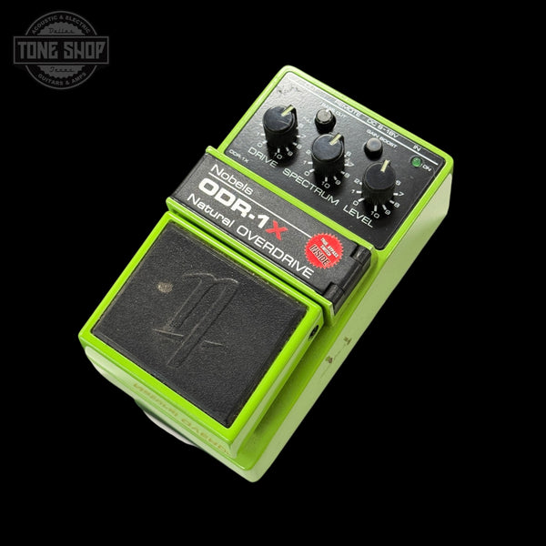 Nobels Guitar effects pedal with green casing and black controls on a white background
