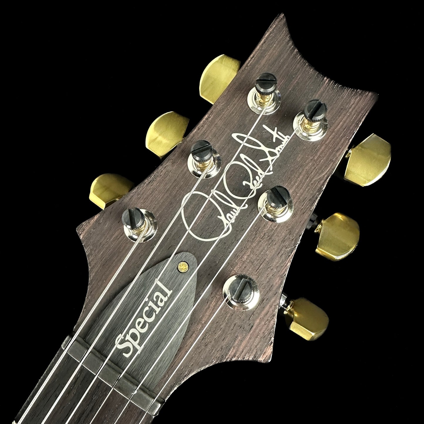 Front of headstock of PRS Special Semi-hollow Orange Tiger.
