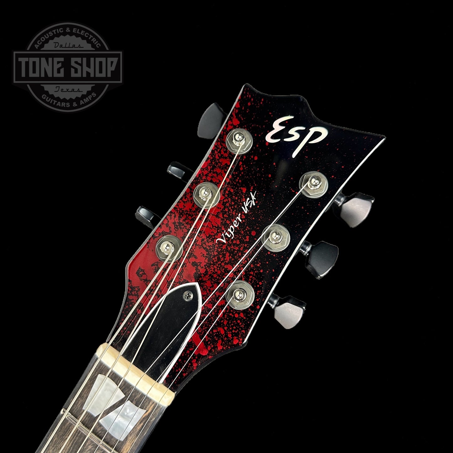 Front of headstock of ESP USA Viper Black Blood Splatter.