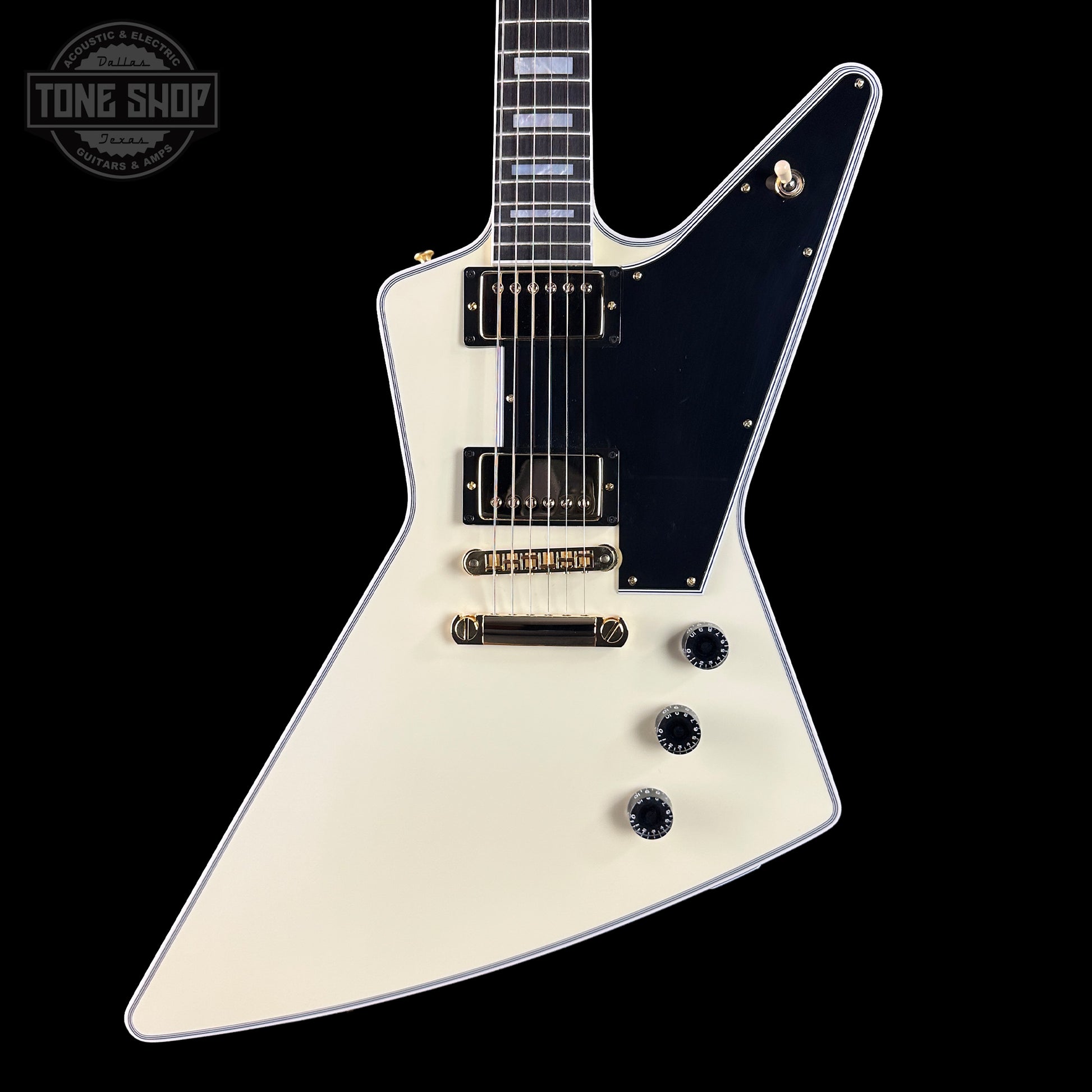 White electric guitar with a black pickguard on a black background, featuring 'Tone Shop' logo.