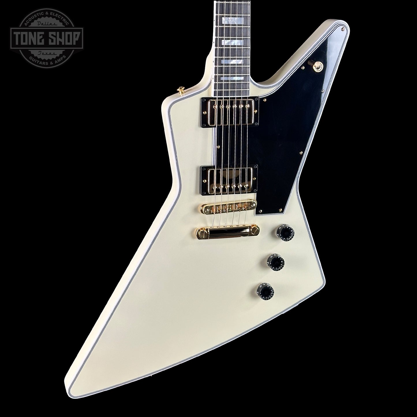 White electric guitar with a black pickguard on a white background, featuring the Tone Shop logo.