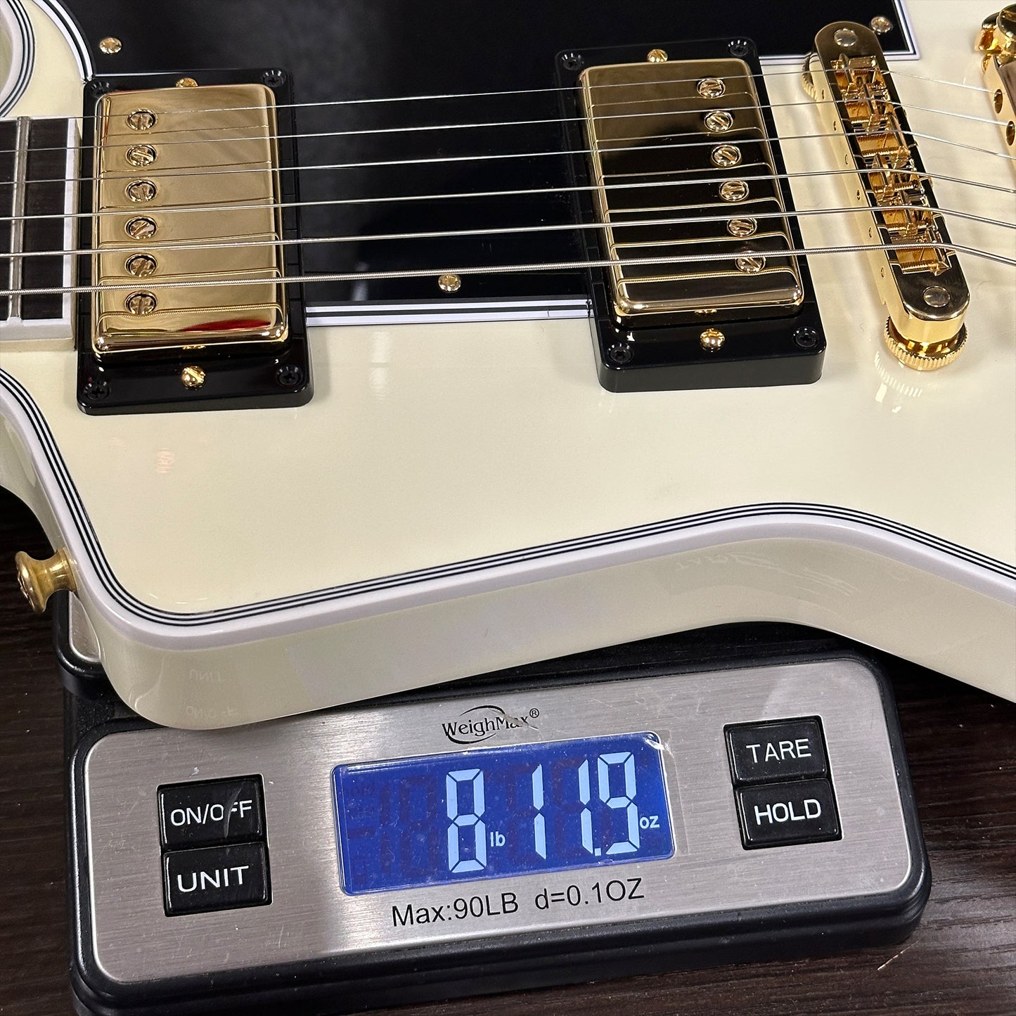 Guitar on a digital scale displaying weight