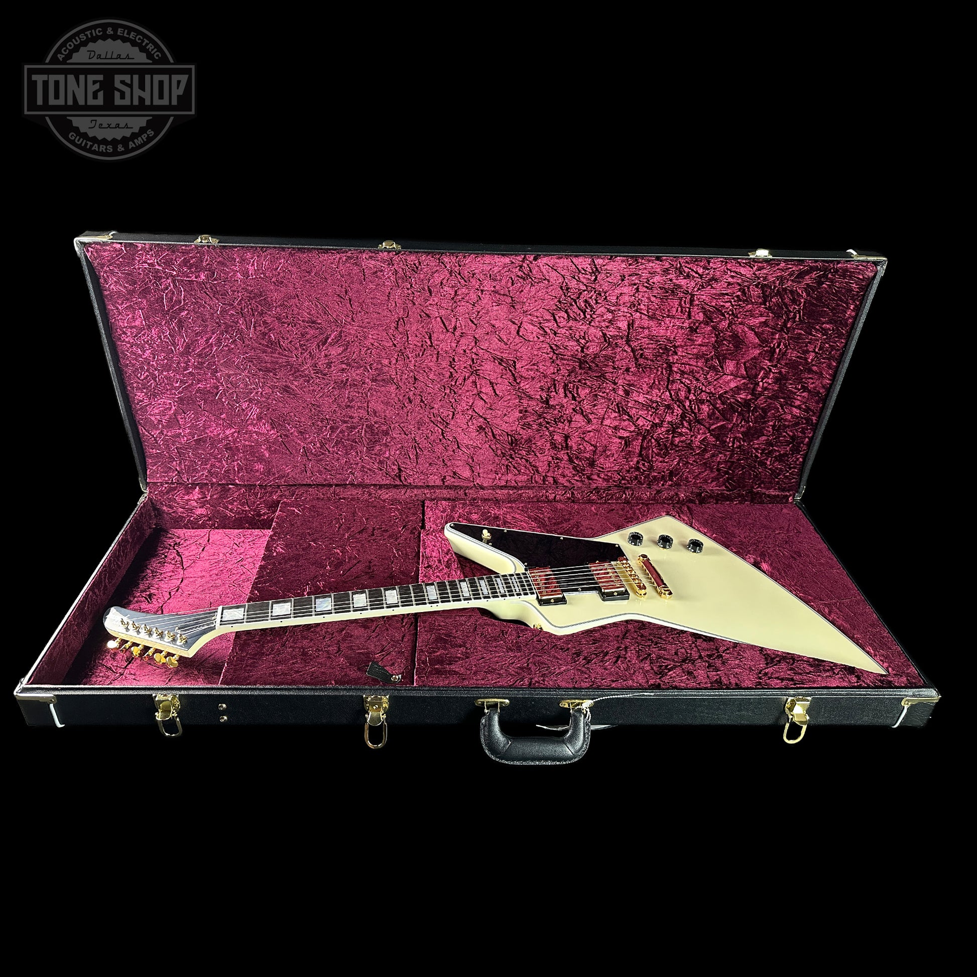 Guitar in a pink case with 'Tone Shop' logo in the corner