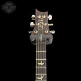 PRS Custom 24 headstock with brand name on a black background