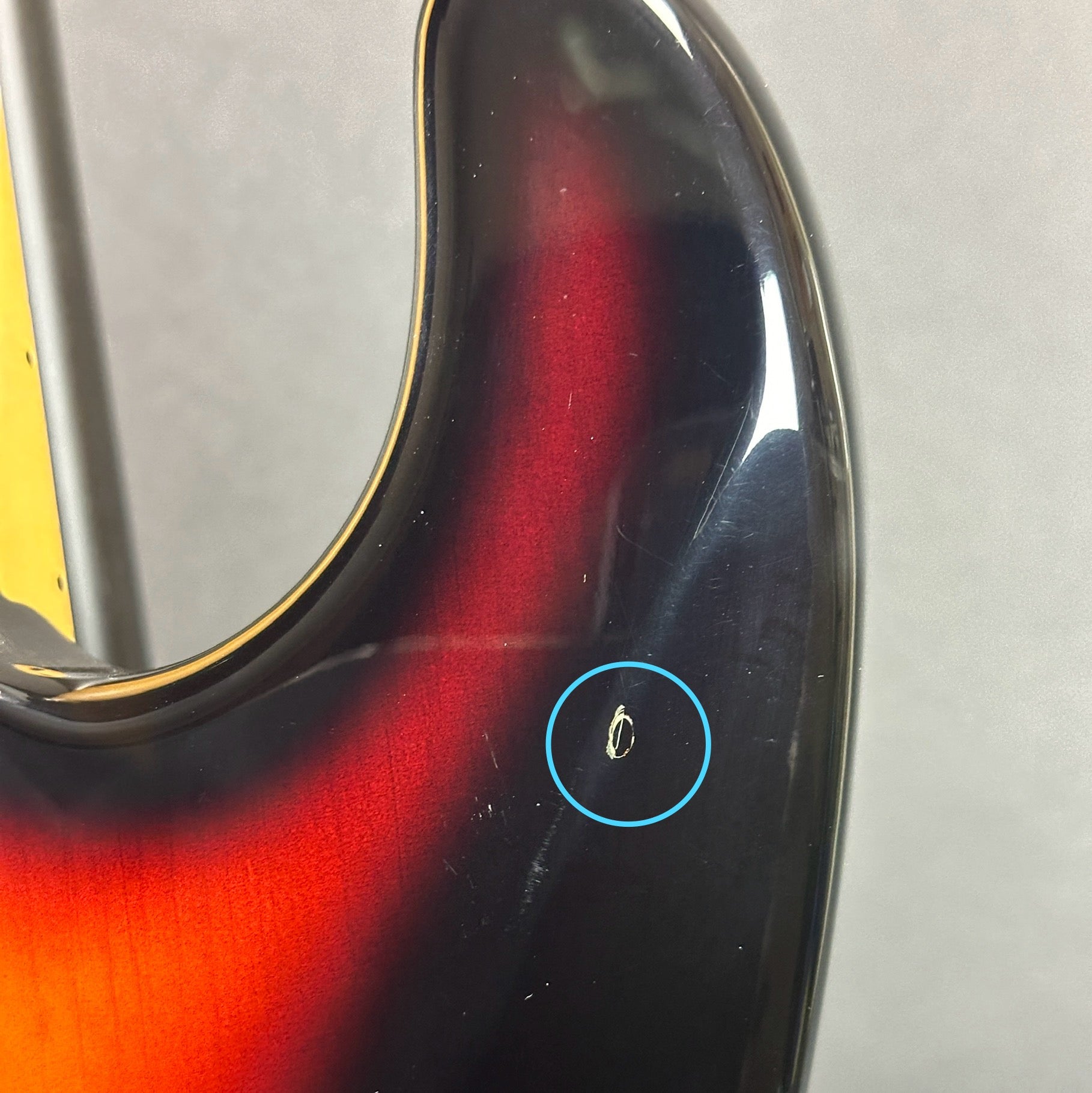 Damage on back of horn of Used 1998 Fender California Strat Sunburst.