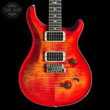 Red Custom 24  electric guitar with a black background