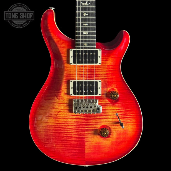 Red Custom 24  electric guitar with a black background