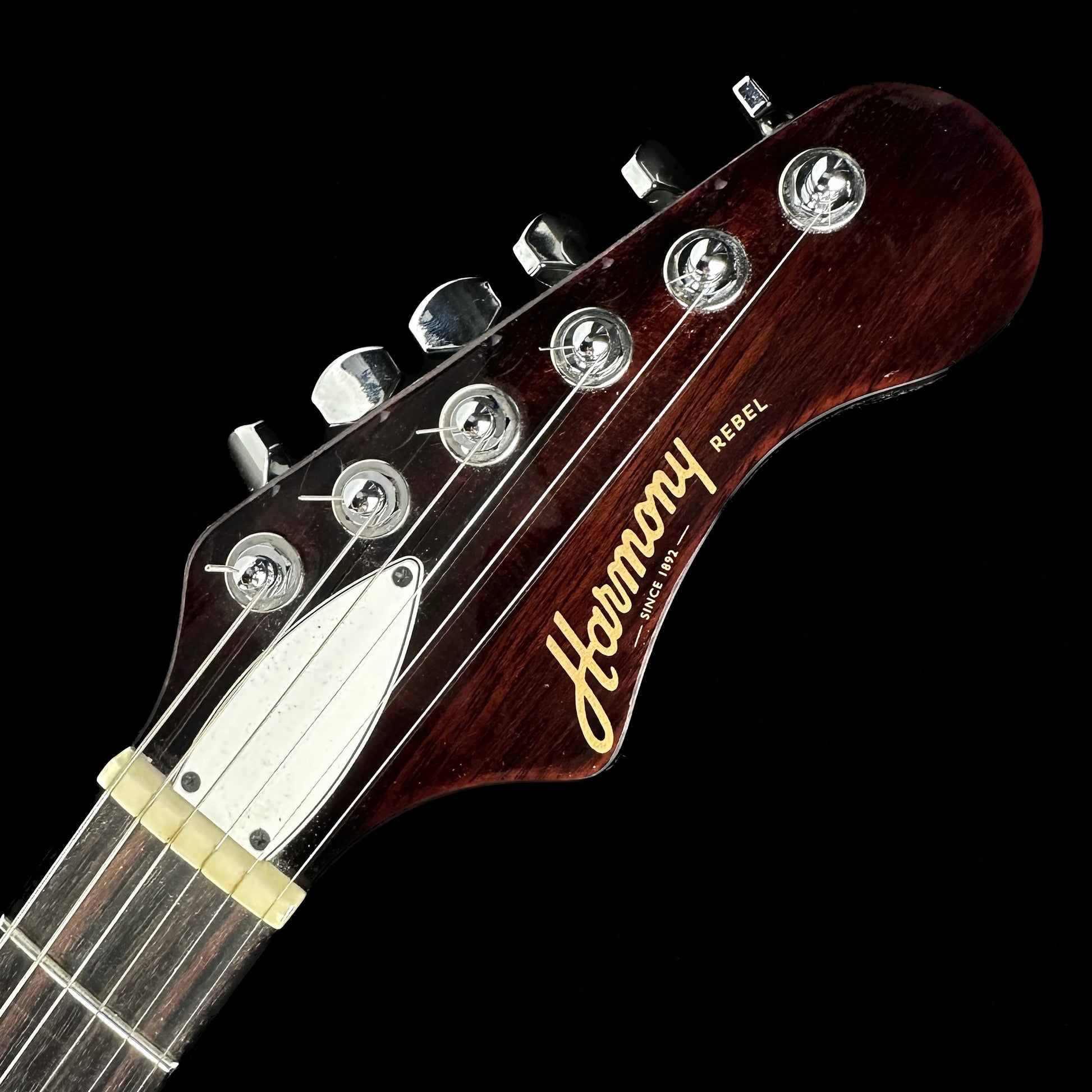 Front of headstock of Used Harmony Rebel White.