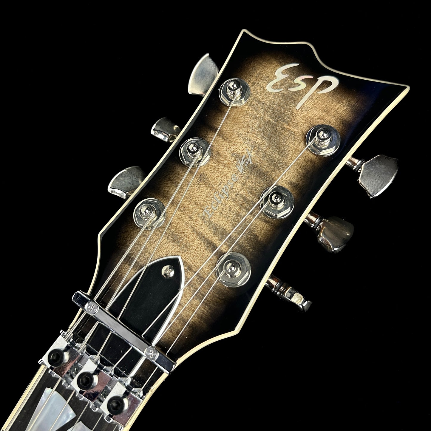 Front of headstock of Demo ESP USA Eclipse Floyd Rose See Thru Black Sunburst.