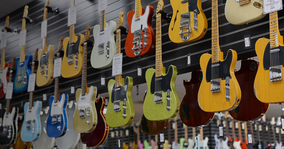 Wall of Fender Custom Shop Telecasters at Tone Shop Guitars in Addison, Texas