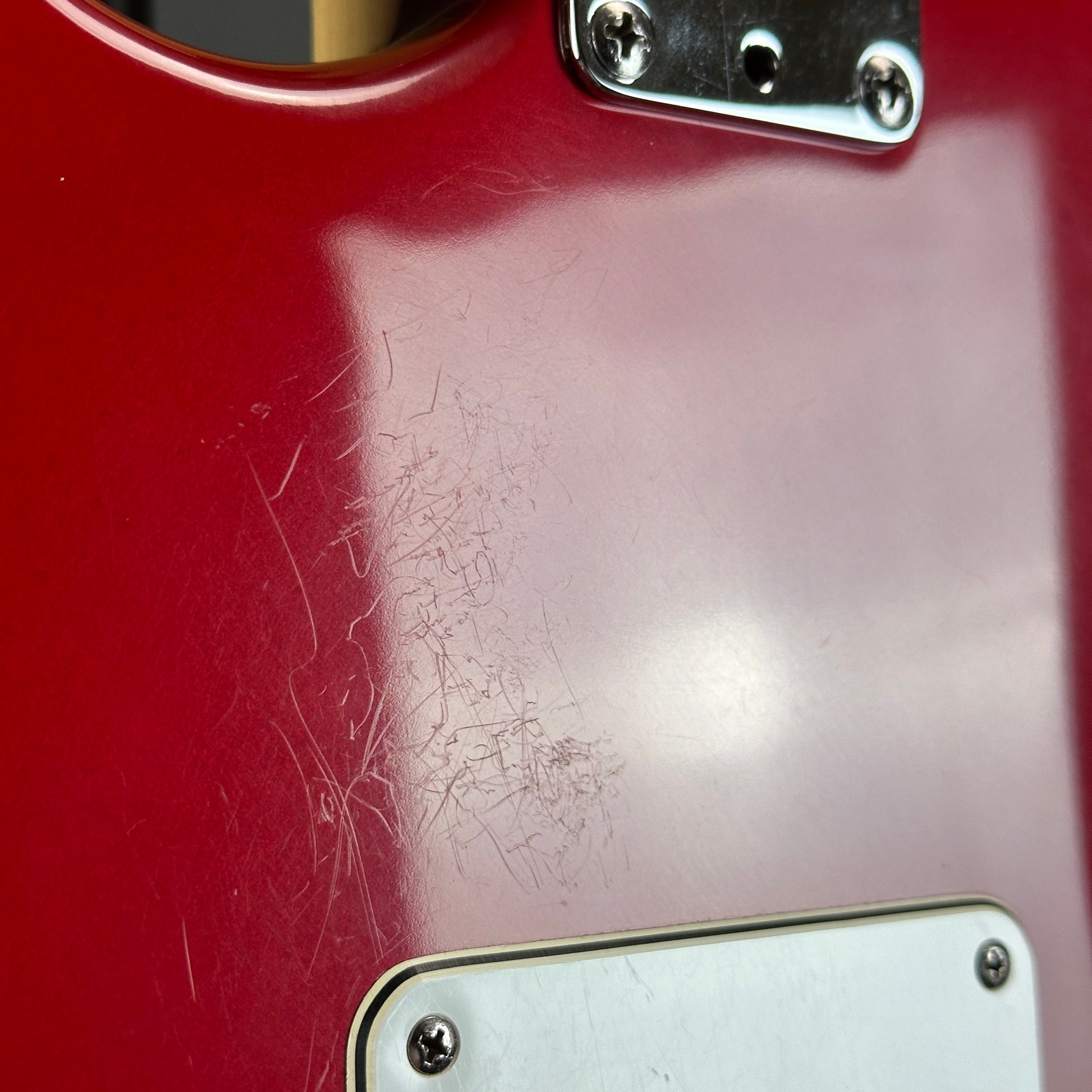 Scratches on back of body of Used 1992 Fender USA Strat Red.