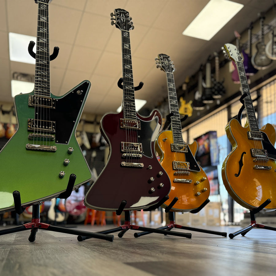 Group of color shifting guitars in a guitar shop.