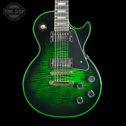 Green electric guitar with a black background