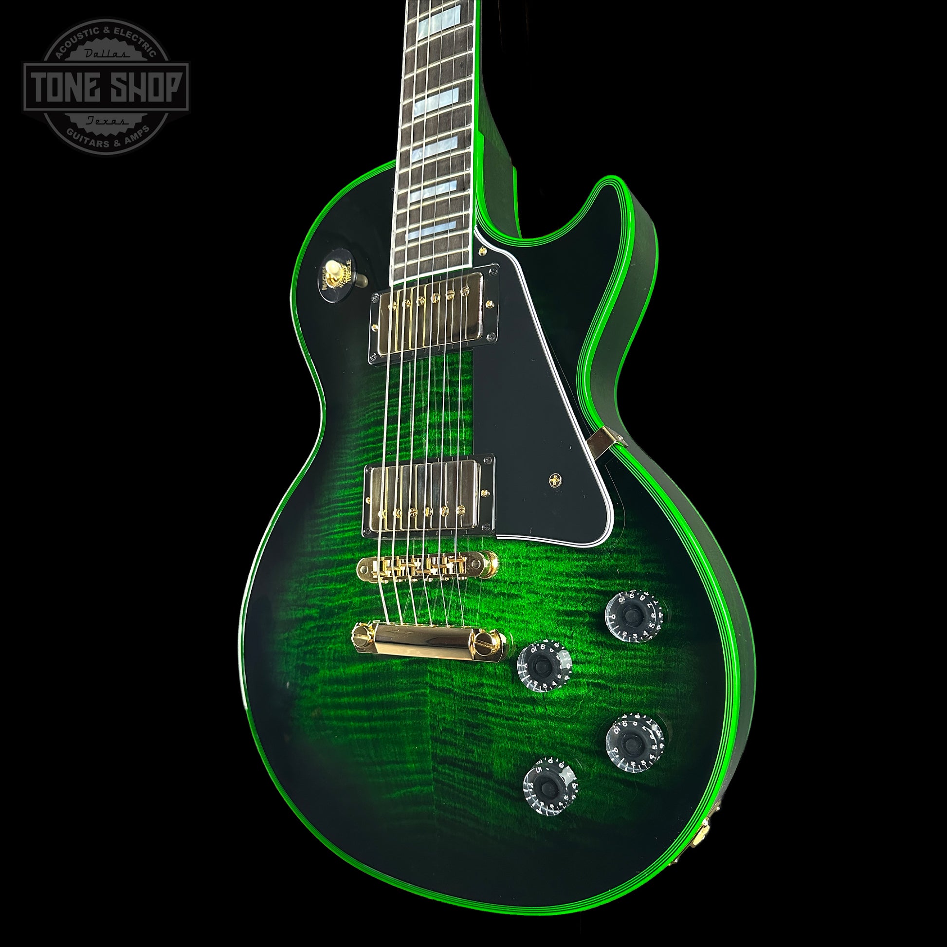 Green electric guitar with a black background, featuring the Tone Shop logo.