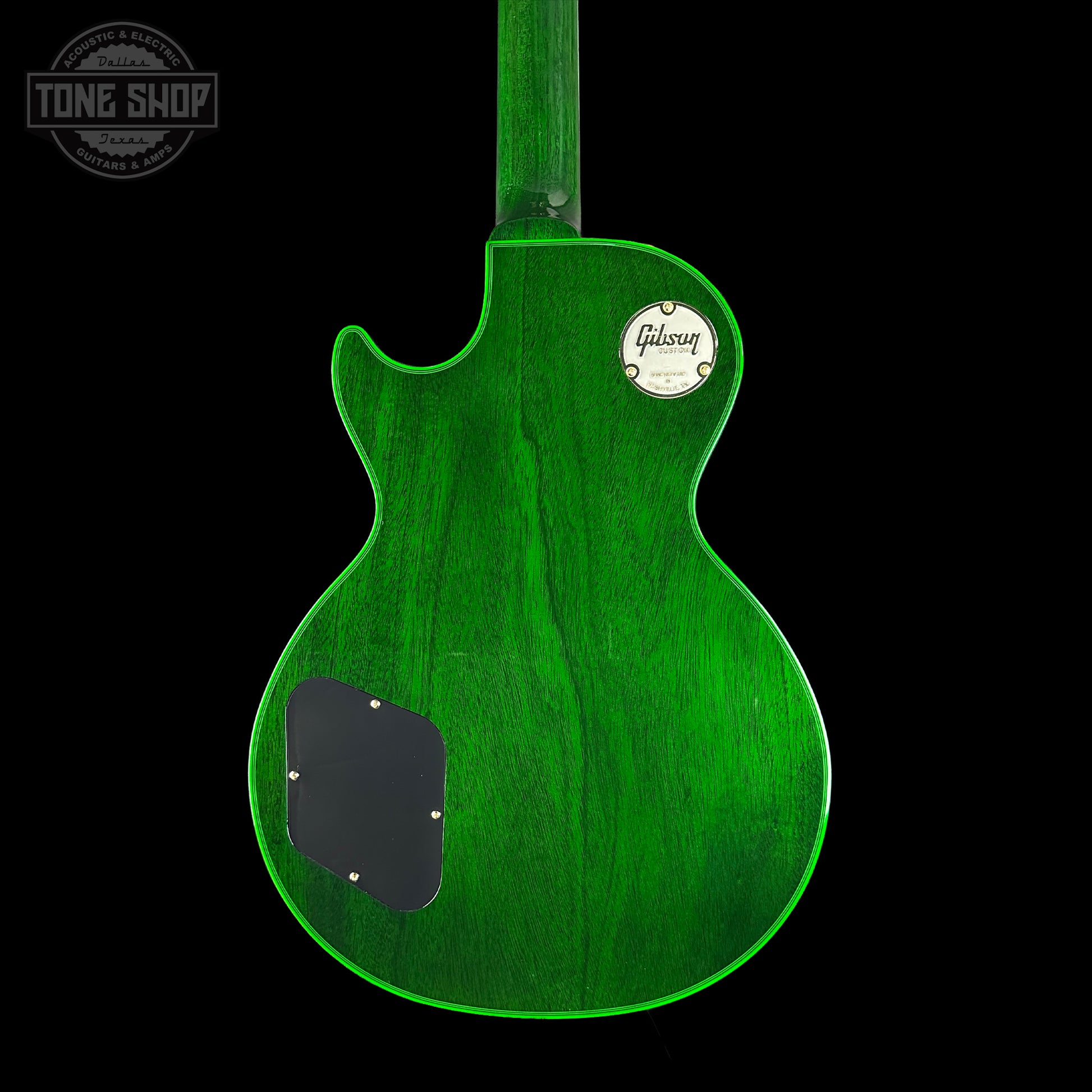 Green electric guitar body with Gibson logo on a black background