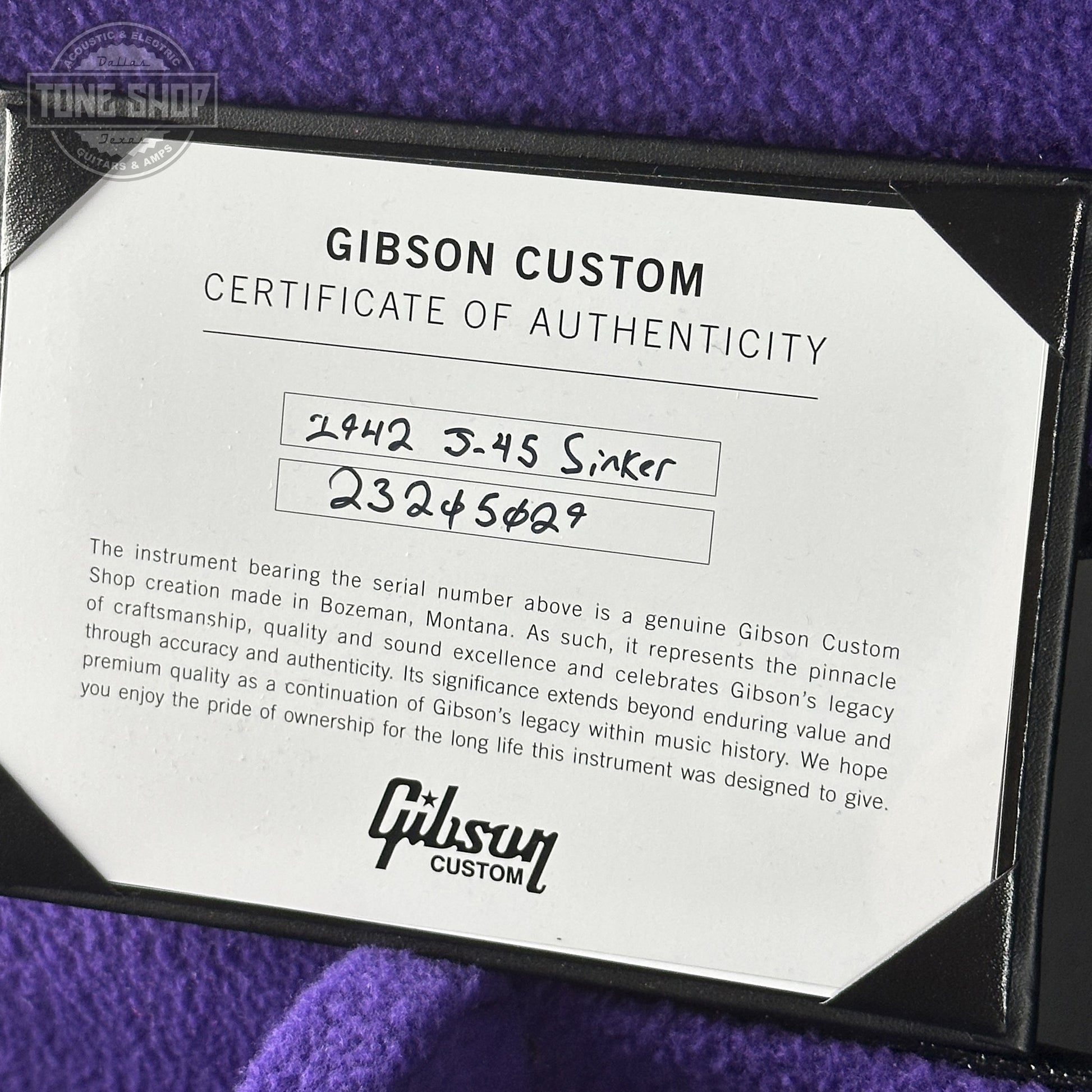 Gibson Custom Certificate of Authenticity on a purple surface