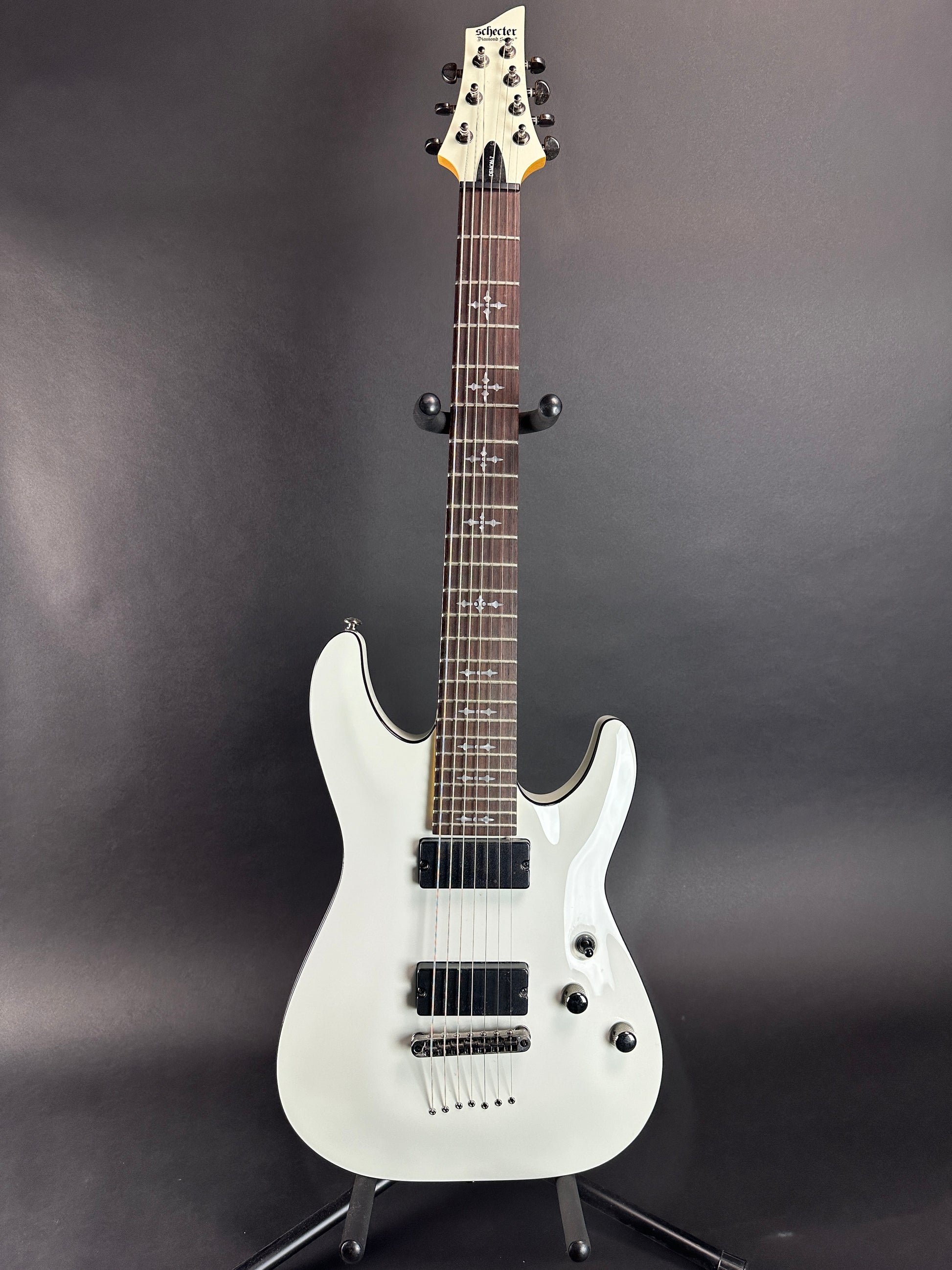 Full front of Used Schecter Demon 7 Vintage White.