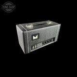 A Melodyne ML-25 guitar amplifier head in a textured black finish, shown at a three-quarter angle on a solid black background. The Melodyne logo is visible on the front, and a Tone Shop watermark is in the top-left corner.