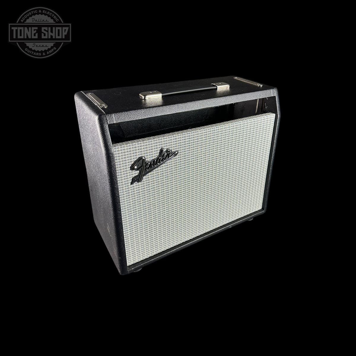 A Fender guitar amplifier speaker cabinet with a black textured exterior, silver grille, and silver handle, shown on a solid black background with a Tone Shop watermark in the top-left corner.