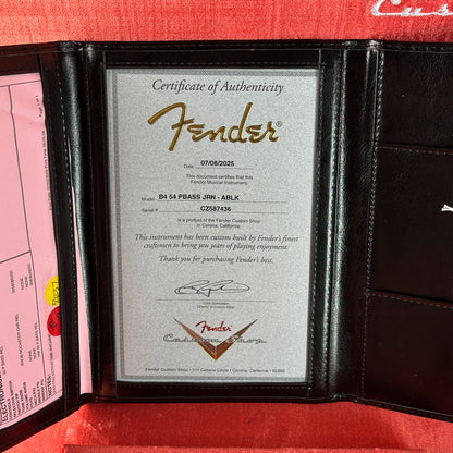 Fender certificate of authenticity in a black leather case with a red interior.