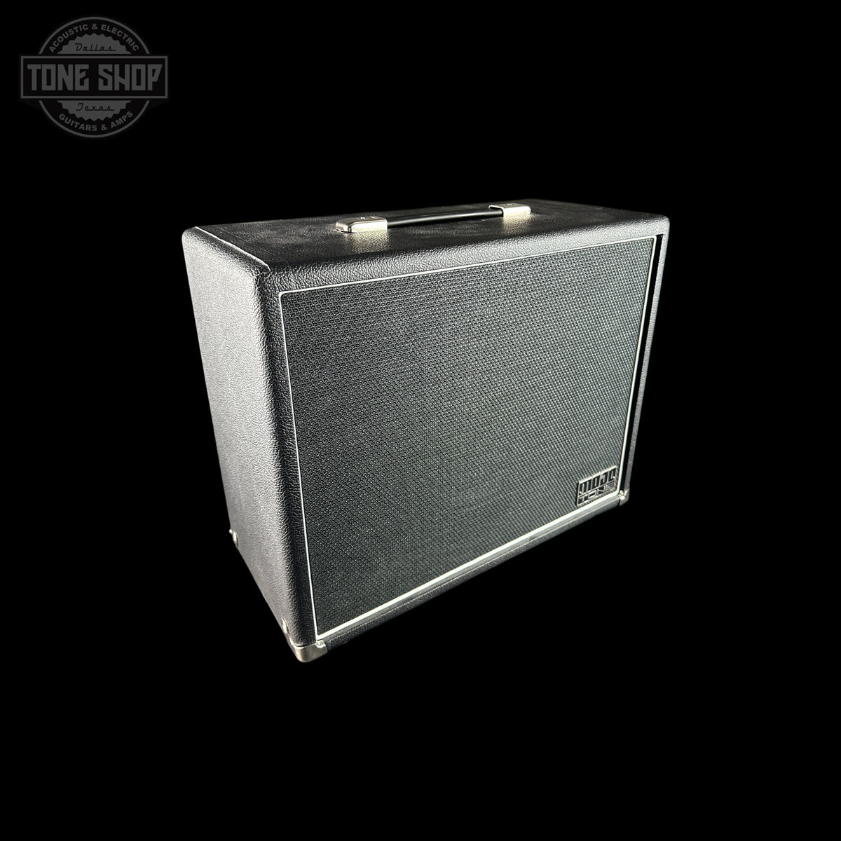A vintage-style guitar amplifier speaker cabinet with a black textured grille and silver metal trim, shown at an angle on a solid black background. A Tone Shop watermark is visible in the top-left corner.