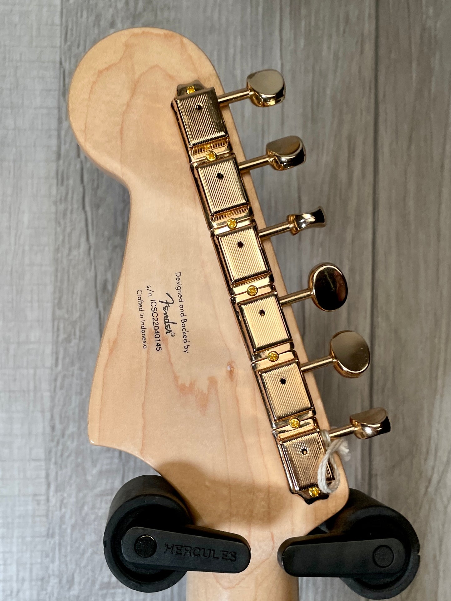 Back headstock view of Used 2022 Squire 40th Anniversary Jazzmaster Gold Edition Olympic White