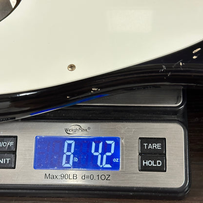 Digital scale displaying weight with blue digital readout on a metallic surface.