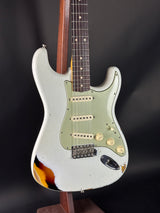 Electric guitar with a sunburst finish on a dark background