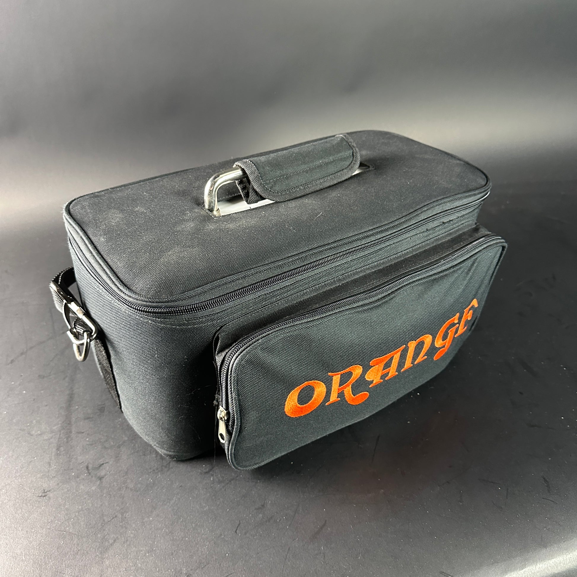Gray carrying case with 'Orange' branding on a gray background
