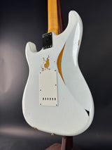 White electric guitar with a worn finish on a dark background