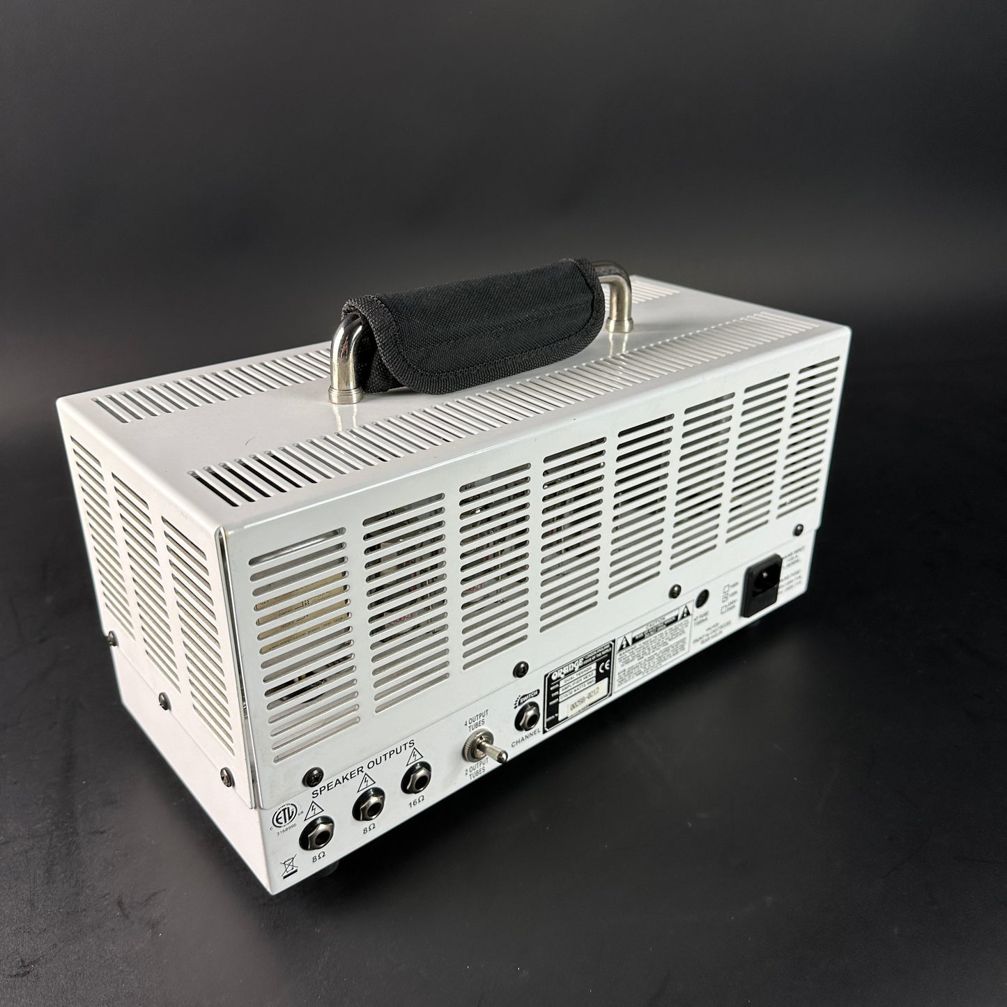 White electronic device with a black handle on a dark background