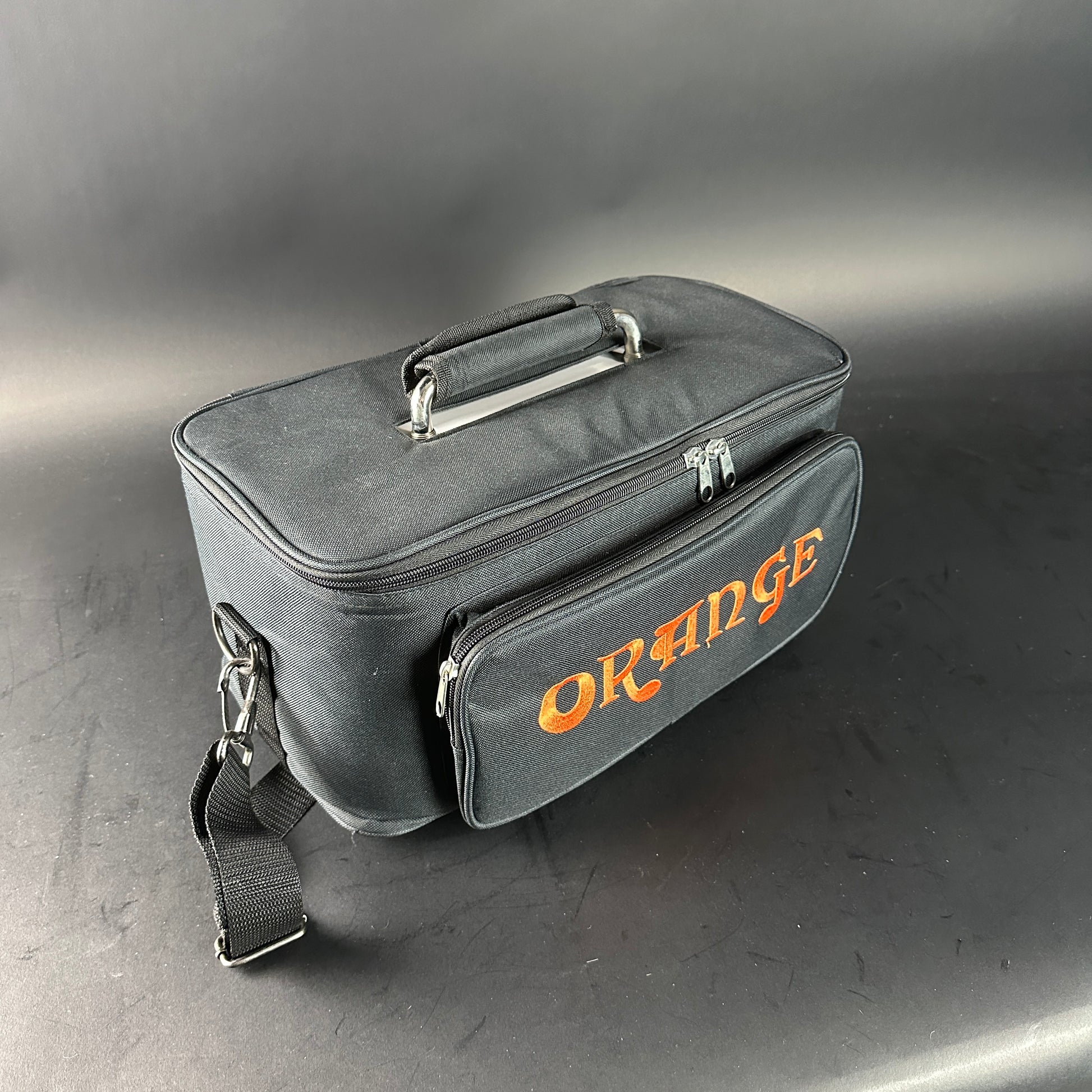Black carrying case with 'Orange' branding on a gray background