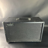 Black guitar amplifier cabinet with 'Mesa Boogie' branding on a gray background