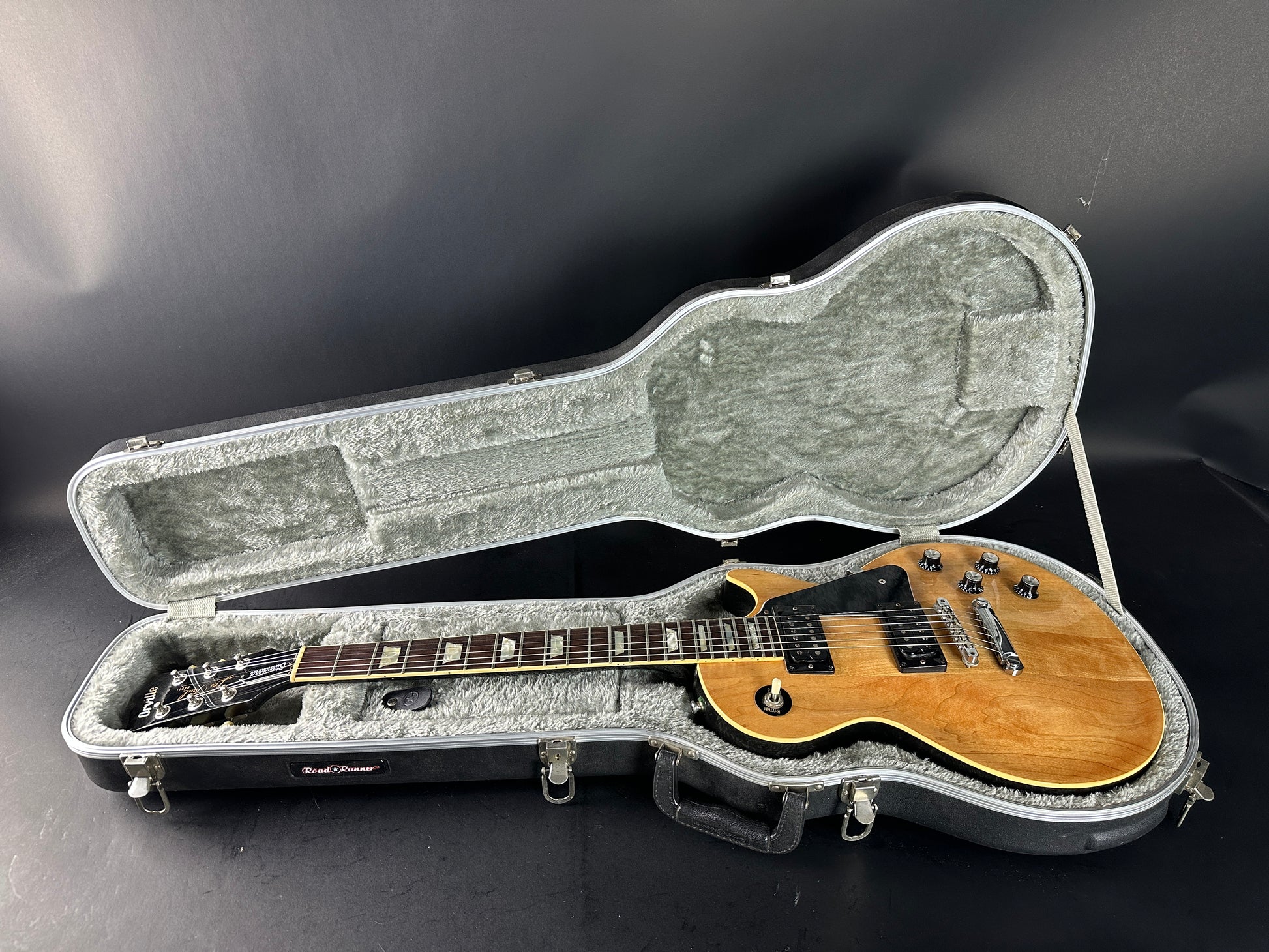 Electric guitar in a hard case on a dark background