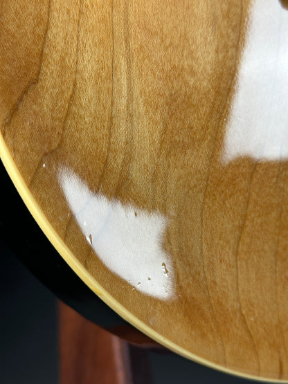 Close-up of a wooden surface with white paint splatter