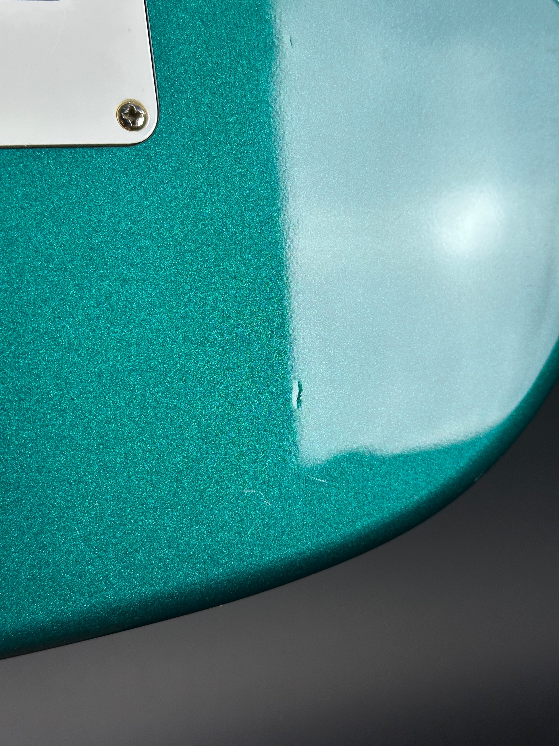 Wear on back of Used Ibanez EX1500 Teal.