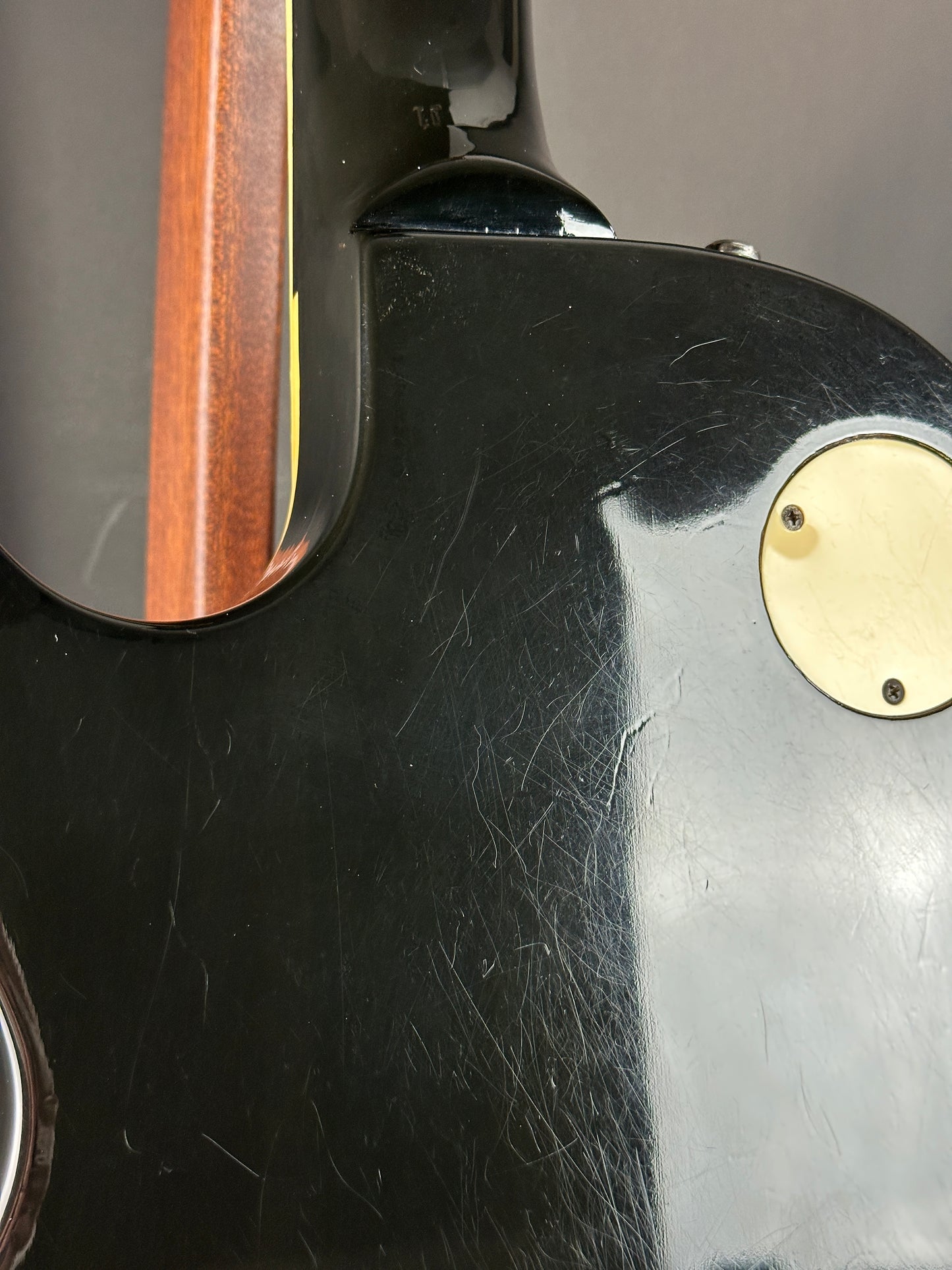 Close-up of a guitar neck with a worn finish