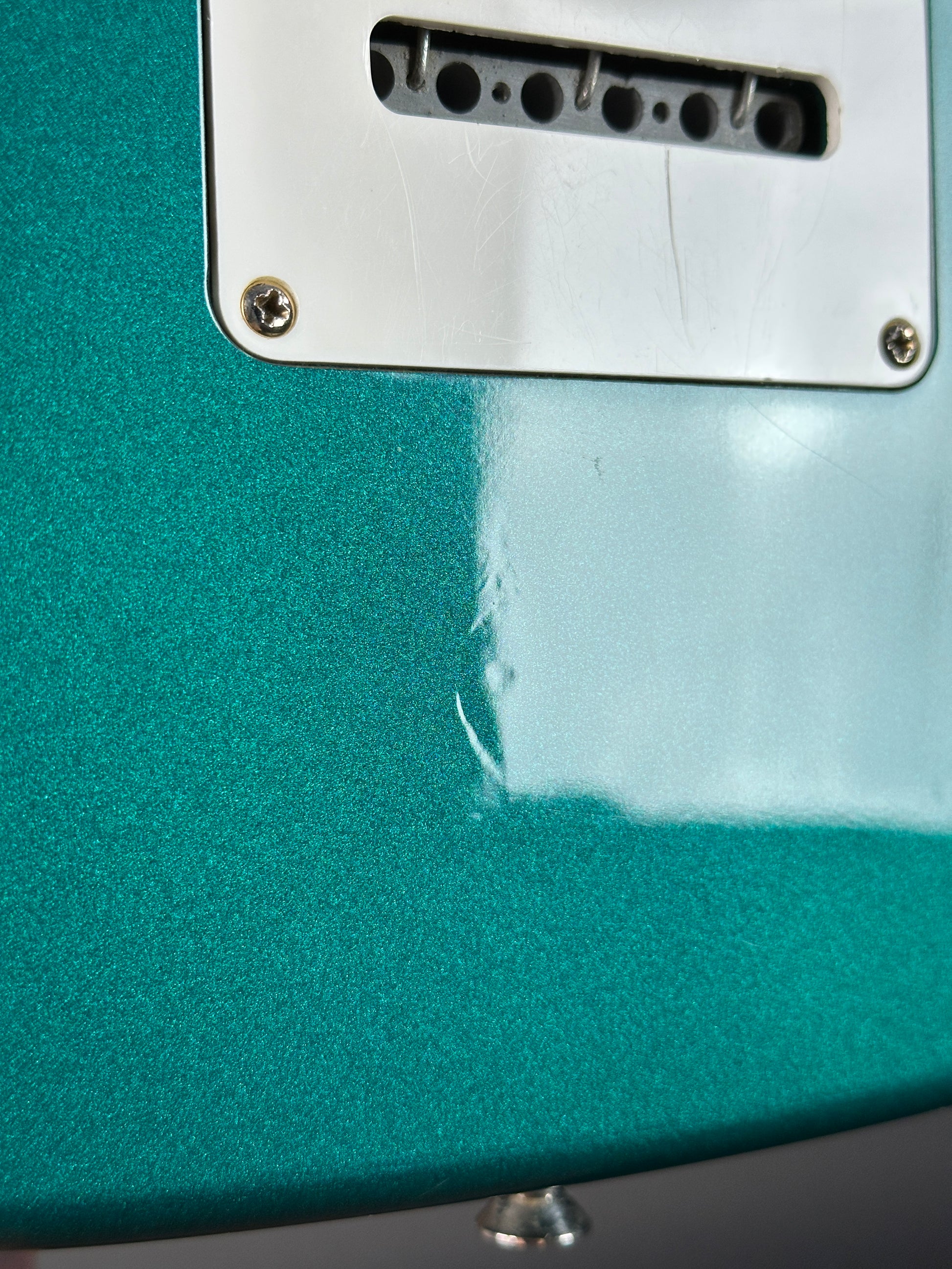 Wear on back of Used Ibanez EX1500 Teal.