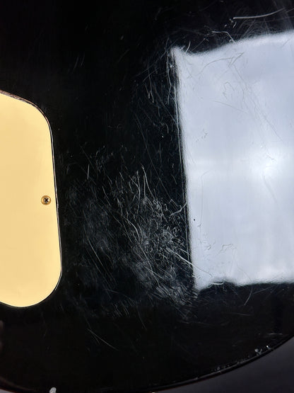 Close-up of a black helmet with a gold emblem on a dark background