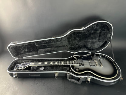 Guitar in an open case on a gray background